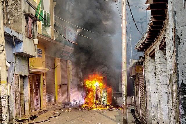 A vehicle in flames after violence erupted during the second survey of the Jama Masjid.
