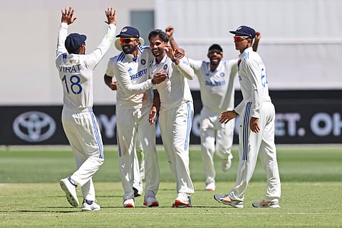 Nitish Kumar Reddy, center, celebrates with teammates the wicket of Australia's Mitchell Marsh on the fourth day of the first cricket test between Australia and India in Perth.