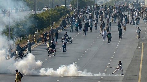 Police fire tear gas shell to disperse supporters of imprisoned former premier Imran Khan's Pakistan Tehreek-e-Insaf party, during clashes, in Islamabad, Pakistan.