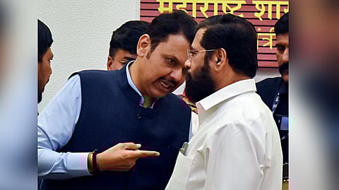 Maharashtra Chief Minister Eknath Shinde in a conversation with Deputy CMs Devendra Fadnavis during a press conference at the Varsha Bungalow in Mumbai on Nov. 23, 2024.