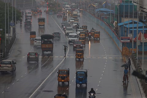 Vehicles ply on a road amid rain in Chennai on Tuesday.