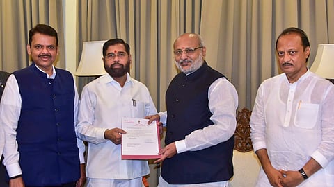 Maharashtra Governor CP Radhakrishnan receives Shiv Sena leader Eknath Shinde's resignation as state chief minister as BJP leader Devendra Fadnavis and NCP leader Ajit Pawar look on in Mumbai, Tuesday, Nov. 26, 2024.