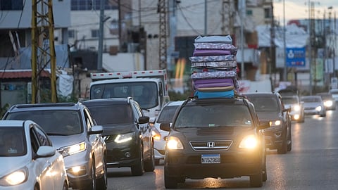 People in their cars return back to their villages after the ceasefire between Hezbollah and Israel began early morning, in Tyre, south Lebanon, Wednesday.