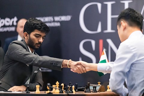 D Gukesh shakes hands with Ding Liren after his win on Wednesday (Photo | FIDE)
