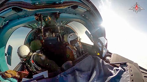 In this photo taken from video released by the Russian Defense Ministry on Thursday, Nov. 28, 2024, pilots of an Su-34 bomber of the Russian air force fly at an undisclosed location in Ukraine.