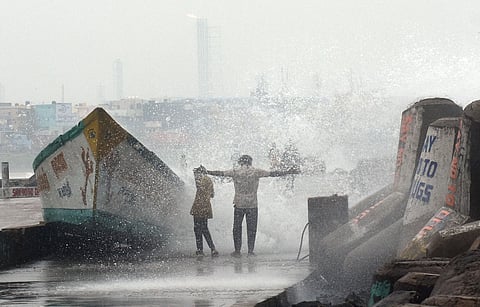 Waves crash against the rocky shore and harbour barriers at Kasimedu fishing harbour as cyclone fengal approaches the coast, creating high tides and turbulent seas.