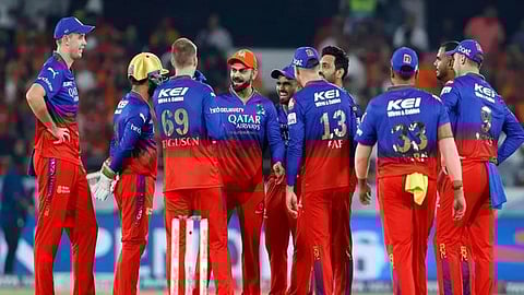 RCB players celebrating a wicket during an IPL match.