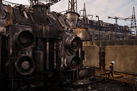 A worker walks in front of a transformer which was destroyed after a recent Russian missile attack at DTEK's power plant in Ukraine, Nov. 28, 2024.