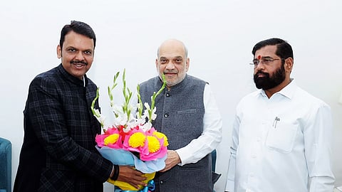 Union Minister and senior BJP leader Amit Shah, Maharashtra BJP leader Devendra Fadnavis, and Shiv Sena leader Eknath Shinde exchange greetings during a meeting at Nadda's residence in New Delhi on Thursday, Nov. 28, 2024.