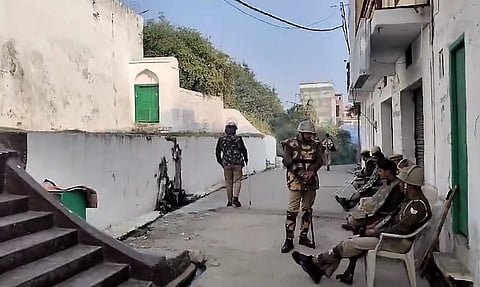 Police and security personnel stand guard near the premises of Shahi Jama Masjid ahead of Friday prayers in Sambhal, Friday, Nov. 29, 2024.