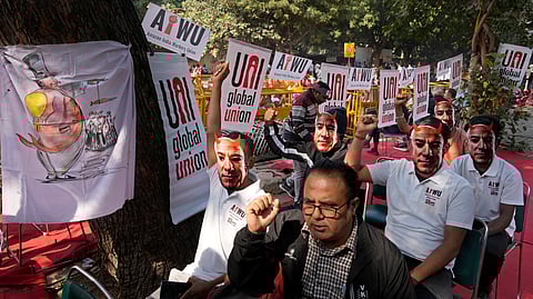 Participants wear paper masks in the likeness of Amazon's Jeff Bezos as warehouse workers and delivery drivers stage a protest against the Seattle-based company demanding higher wages and better working conditions, in New Delhi, India, Friday, Nov. 29, 2024.