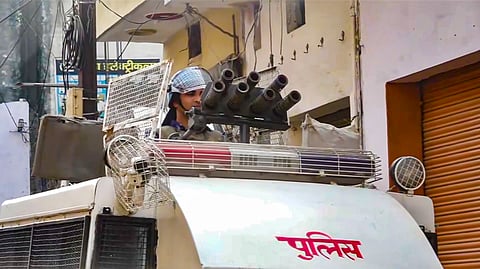 A security official keeps a vigil ahead of Friday prayers, in Sambhal, Friday, Nov. 29, 2024.