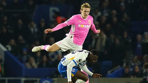 Southampton's Flynn Downes, top, and Brighton and Hove Albion's Danny Welbeck battle for the ball during the Englidh Premier League match at the American Express Stadium.