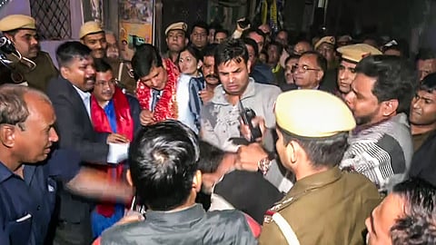 A person throws water on former Delhi CM and Aam Aadmi Party (AAP) national convener Arvind Kejriwal during his padyatra, at Greater Kailash in New Delhi on Saturday.