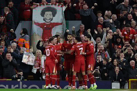 Liverpool's Dutch striker #18 Cody Gakpo (C) celebrates with teammates after scoring the opening goal of the EPL football match between Liverpool and Manchester City
