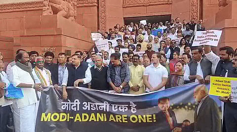 Lawmakers from the Congress-led INDIA bloc protest outside the parliament over the US indictment and bribery charges against billionaire Gautam Adani in New Delhi on Tuesday, Dec. 3, 2024.