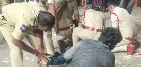 Screengrab of police personnel trying to help the injured outside the Sandhya theatre at Musheerabad in Hyderabad on Wednesday