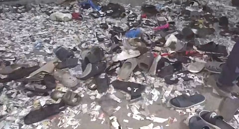 Footwears lie on the floor during the premiere show of Telugu film 'Pushpa 2', in Hyderabad, Wednesday night, Dec. 4, 2024.