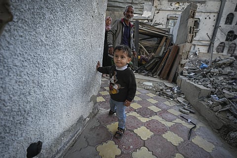 Osaid Shaheen, who is nearly 2, stands against a wall in Deir al-Balah, Gaza Strip, Nov 15, 2024.