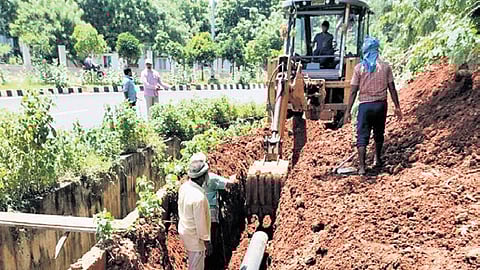 Workers seen installing pipelines to supply water to AIIMS