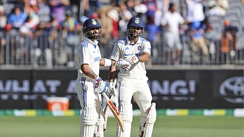 Nitish Kumar Reddy, right, and teammate Virat Kohli touch gloves as they bat on the third day of the first cricket test between Australia and India in Perth, Australia, Sunday, Nov. 24, 2024.