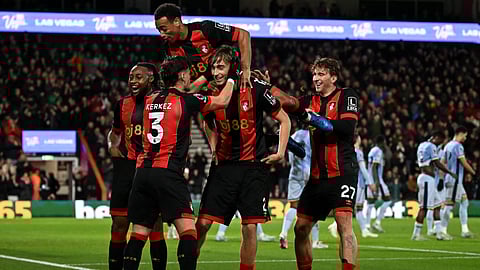 Bournemouth's Spanish defender #02 Dean Huijsen (C) is mobbed by teammates after scoring the teams first goal during the EPL football match between Bournemouth and Tottenham Hotspur