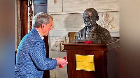 Governor of Nebraska Jim Pillen pays tribute after unveiling a bust of Mahatma Gandhi at the governor's office on the Nebraska State Capitol premises in Lincoln, Nebraska, USA, Friday, Dec. 6, 2024.