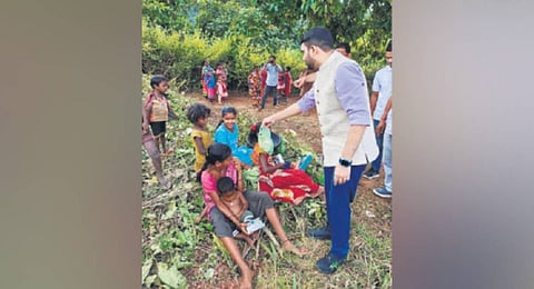 Kalahandi collector Sachin Pawar distributing food among tribals