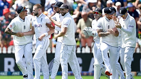 England bowler Gus Atkinson celebrating with teammates after taking a hat trick during play on day two of the second cricket test between New Zealand and England at the Basin Reserve in Wellington, New Zealand.