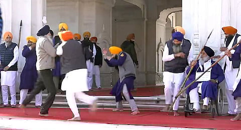 People catch a man who allegedly opened fire at Shiromani Akali Dal leader Sukhbir Singh Badal while the latter was serving the 'tankhah' (religious punishment) given by the Akal Takht at the Golden Temple, in Amritsar, Wednesday, Dec. 4, 2024.