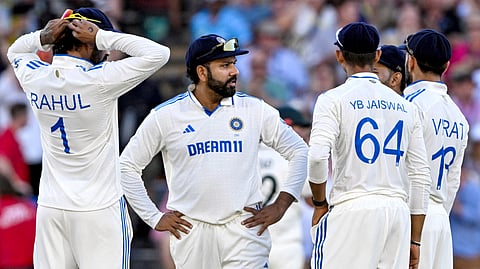 India's captain Rohit Sharma (2L) speaks with teammates on the second day of the second cricket Test match between Australia and India at the Adelaide Oval in Adelaide.