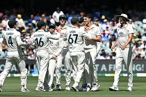 Australia's captain Pat Cummins (2nd R) celebrates his dismissal of India's Nitish Kumar Reddy with teammates on the third day of the second Test cricket match between Australia and India at the Adelaide Oval in Adelaide on December 8, 2024.