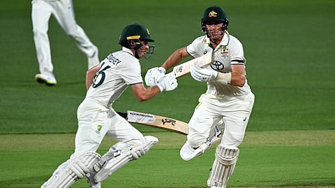 Australian batsmen Nathan McSweeney (L) and Marnus Labuschagne (R) take a quick single on the first day of the second cricket Test match between Australia and India at the Adelaide Oval in Adelaide on December 6, 2024.