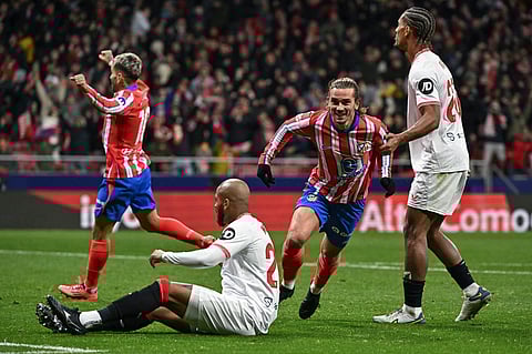 Atletico Madrid's French forward #07 Antoine Griezmann (2R) celebrates scoring their fourth goal during the Spanish league football match between Club Atletico de Madrid and Sevilla FC at the Metropolitano stadium in Madrid on December 8, 2024.