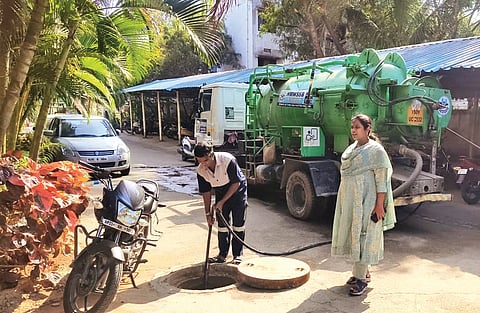 HMWSSB workers desilt a manhole in the city
