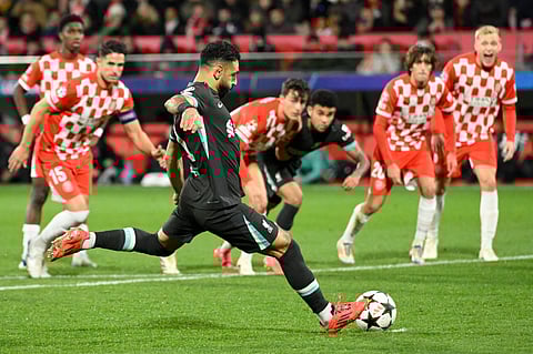 Liverpool's Egyptian forward Mohamed Salah shoots from the penalty spot and scores the opening goal during the UEFA Champions League, league phase football match between Girona FC and Liverpool FC