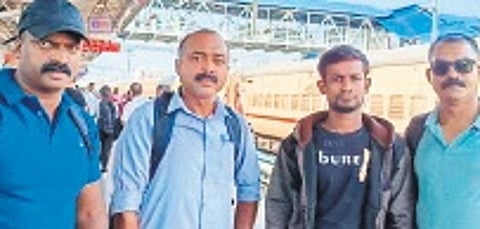 Police officers with Shahin Molla (in jacket)