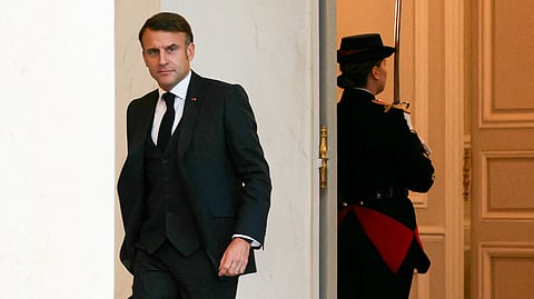 French President Emmanuel Macron leaves after the weekly cabinet meeting at the presidential Elysee Palace in Paris on December 11, 2024.
