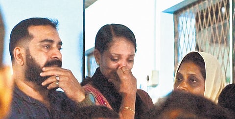 Relatives and teachers of the deceased students weep as the bodies arrive at the Palakkad District Hospital.