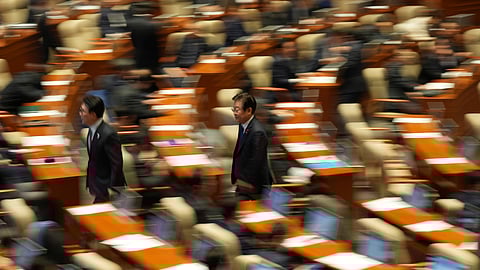 South Korea's main opposition Democratic Party leader Lee Jae-myung, center, walks back to his seat after he voted on an impeachment bills for the national police chief Cho Ji Ho and justice minister Park Sung Jae during a plenary session held relating to the martial law declaration, at the National Assembly in Seoul, South Korea on Thursday.
