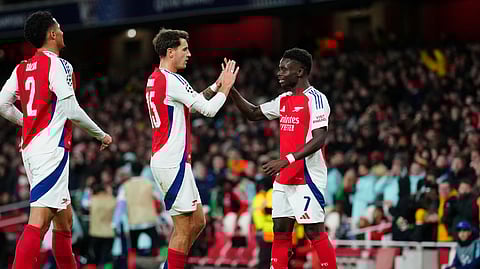 Arsenal's Bukayo Saka, right, celebrates with teammates after scoring his side's second goal during the Champions League opening phase football match between Arsenal and Monaco, at the Emirates Stadium in London.