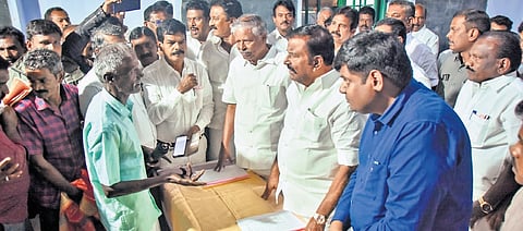 Minister K N Nehru interacting with former tea estate workers at a government-aided school in Manjolai on Thursday