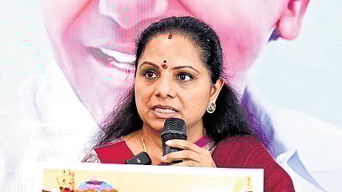 BRS MLC K Kavitha shows a picture of Sonia Gandhi with Bathukamma as she addresses the media at her residence in Hyderabad on Friday