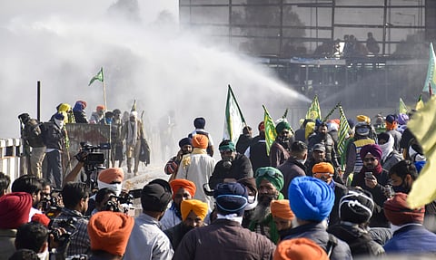 Security personnel use water cannons to disperse farmers agitating at Shambhu border, in Patiala district, Punjab, Saturday, Dec. 14, 2024.