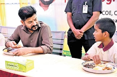 Chief Minister A Revanth Reddy and Deputy Chief Minister Mallu Bhatti Vikramarka share a meal with students of government-run educational institutions at Chilkur and Bonkal respectively as part of the launch of the uniform diet menu on Saturday.