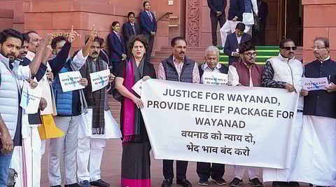 Congress MP Priyanka Gandhi and others stage a protest demanding a relief package for landslide-hit Wayanad during the Winter session of Parliament, in New Delhi.