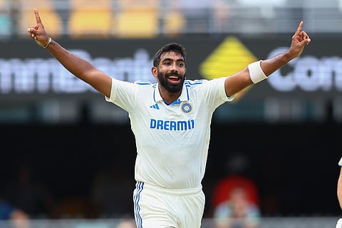India's Jasprit Bumrah celebrates after taking the wicket off Australia's Usman Khawaja during play on day two of the third cricket test between India and Australia at the Gabba.