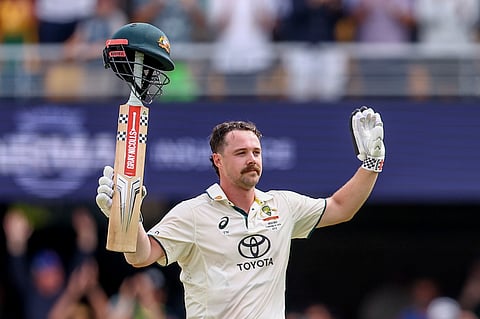 Australia's Travis Head celebrates after scoring a century during play on day two of the third cricket test between India and Australia at the Gabba in Brisbane, Australia, Sunday, Dec.15, 2024.