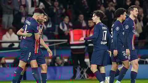 PSG's Goncalo Ramos, left, celebrates with teammates after scoring his side's third goal during the French League One soccer match between Paris Saint-Germain and Lyon at the Parc des Princes in Paris.