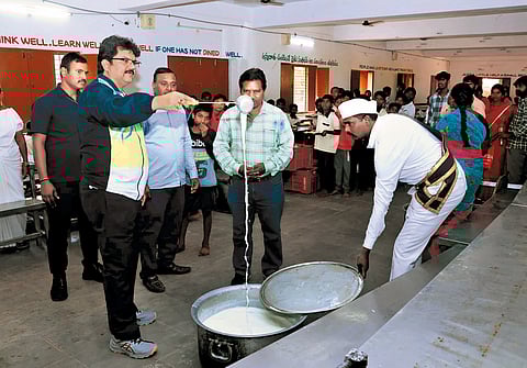 District Collector M Hanumantha Rao checks the quality of buttermilk at the social welfare residential school in Bhuvanagiri on Monday